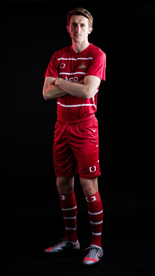 Tom Anderson models the new Doncaster Rovers home kit for the 2021/22 season