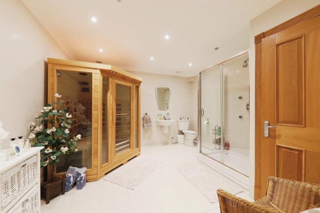 A deluxe shower room with a built-in sauna, for wellbeing and relaxation.