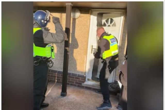 Police smash the door down to force their way into the property in Stainforth.