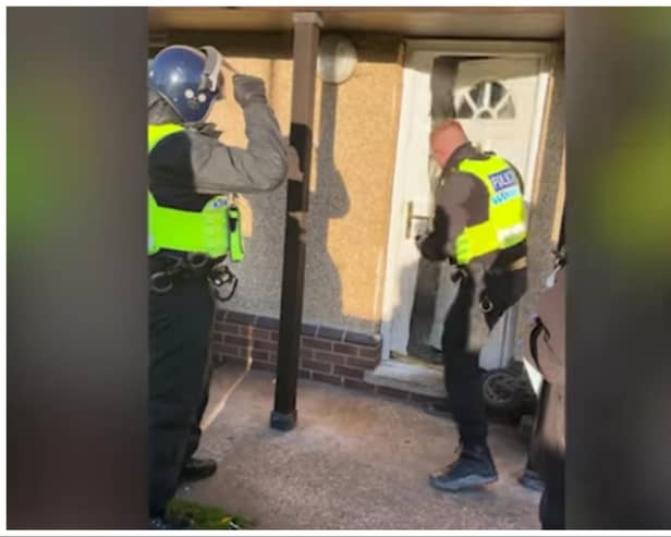 Police smash the door down to force their way into the property in Stainforth.