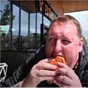 Takeaway fan Danny Malin gets stuck into his Urban burger in Doncaster. (Photo: YouTube).