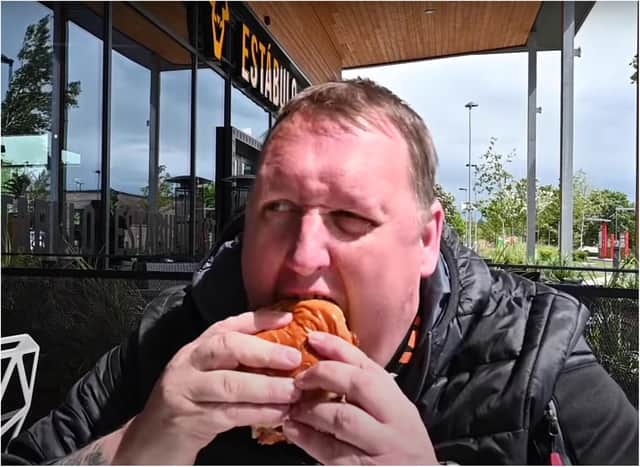 Takeaway fan Danny Malin gets stuck into his Urban burger in Doncaster. (Photo: YouTube).