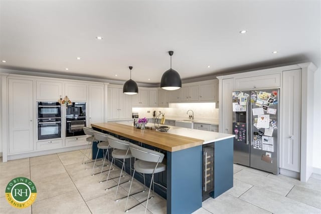 The high spec kitchen with central island and breakfast bar.