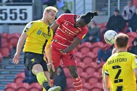 Joe Dodoo heads home Rovers' opening goal. Picture: Andrew Roe/AHPIX LTD