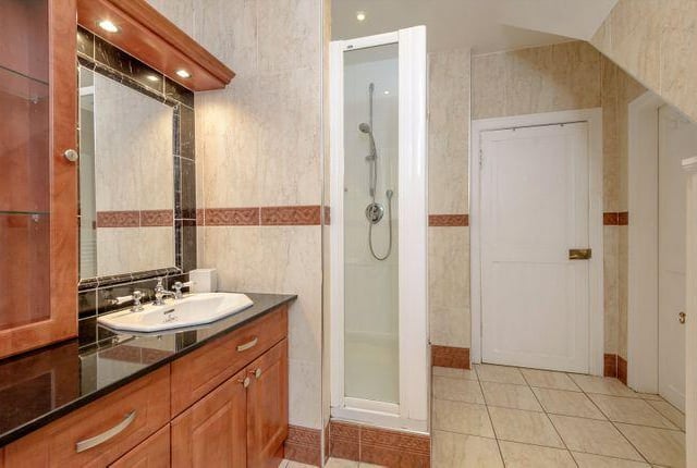 Classy, wood panelled bathroom with perfect soft lighting.