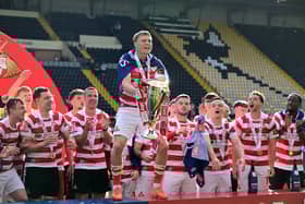 Jay McGrath lifting the League Two trophy