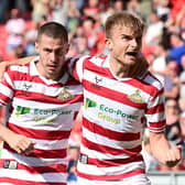 Doncaster's George Miller celebrates his equaliser with Tommy Rowe, who grabbed the assist.