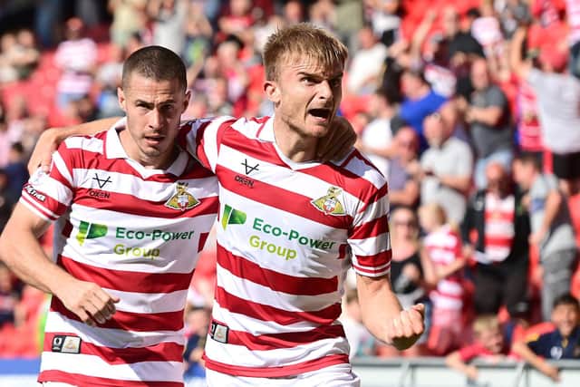 Doncaster's George Miller celebrates his equaliser with Tommy Rowe, who grabbed the assist.