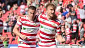 Doncaster's George Miller celebrates his equaliser with Tommy Rowe, who grabbed the assist.