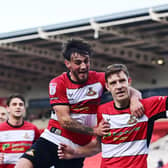 Doncaster Rovers pair Joe Ironside and Tom Nixon celebrate a goal.
