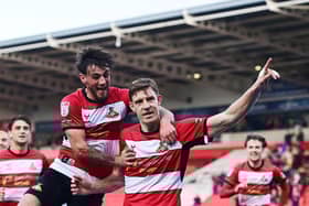Doncaster Rovers pair Joe Ironside and Tom Nixon celebrate a goal.