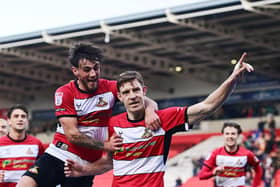 Doncaster Rovers pair Joe Ironside and Tom Nixon celebrate a goal.