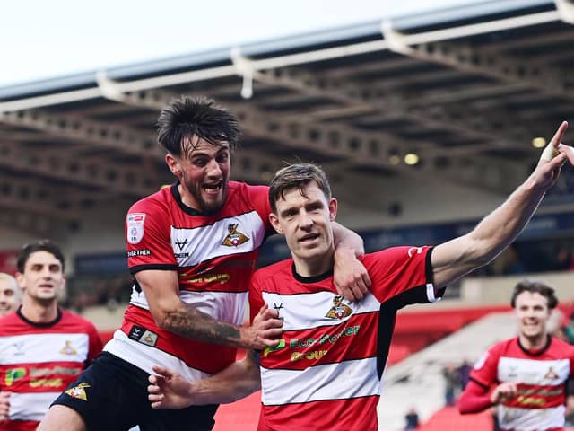 Doncaster Rovers pair Joe Ironside and Tom Nixon celebrate a goal.