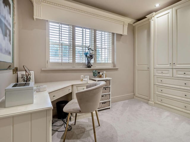A dressing room with fitted furniture.