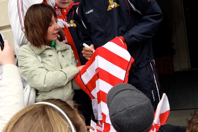 Jason Price signs autographs for his fans that are waiting outside the Mansion House