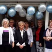 Father Darren with church volunteers at the 2019 opening of their bookshop.