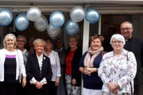 Father Darren with church volunteers at the 2019 opening of their bookshop.