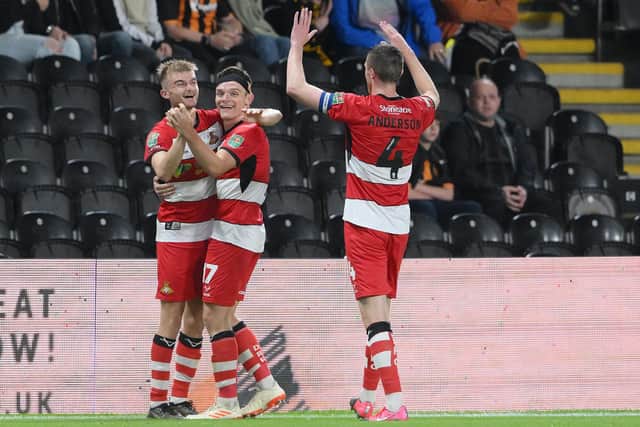 Doncaster's George Miller celebrates his second goal with Owen Bailey and Tom Anderson.