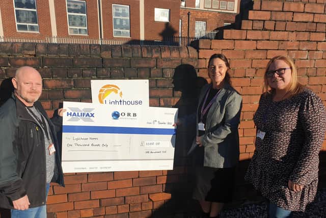 Vanessa Ogden (centre) from ORB Recruitment hands over a Christmas donation to Lighthouse Homes