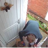 The man can be seen removing items from the box before stuffing them into a plastic bag.