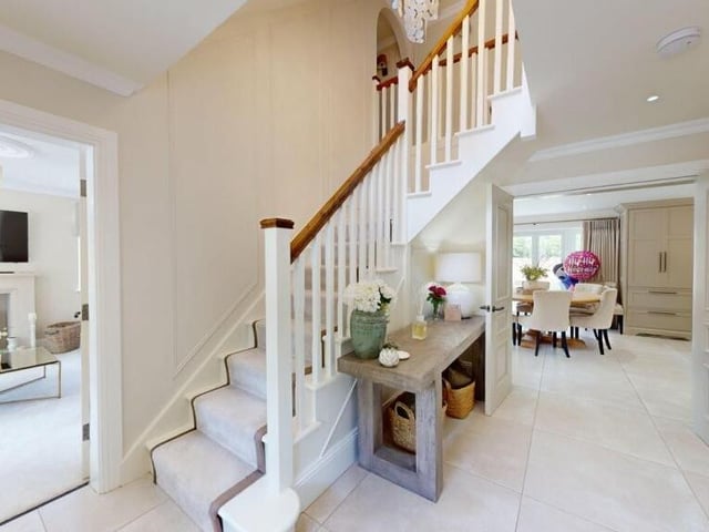 A spacious hallway, with staircase leading up.