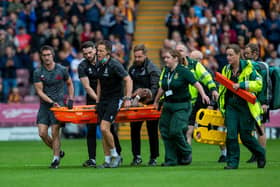 Emmanuel Osadebe is taken off on a stretcher.