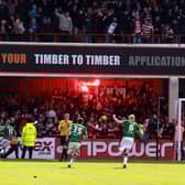 Doncaster Rovers players and fans celebrate James Coppinger's title-clinching goal.