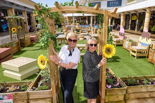 The Village Green will be open during centre opening times and the golf equipment can be picked up from Bensons Outlet. Pictured: Di Mellis and Abby Chandler