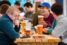 Members of the public enjoy their first drink in a beer garden (Photo by Jeff J Mitchell/Getty Images)