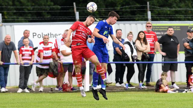 Tommy Rowe goes up for an aerial challenge against Rossington Main. Picture: Andrew Roe/AHPIX