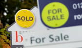 File photo of a sold and for sale signs.