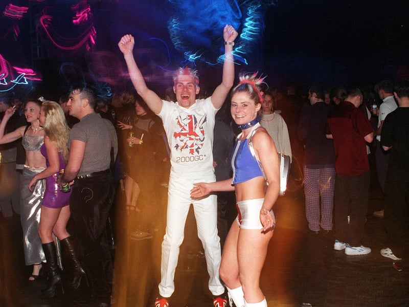 Millennium revellers at the Don Valley stadium for the Gatecrasher event with one wearing the branded 2000GC merchandise T-shirt