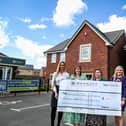 Barratt representatives hand over a giant cheque for £1,500 to Doncaster Foodbank