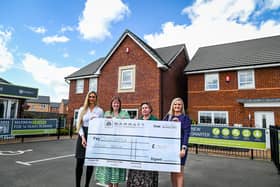 Barratt representatives hand over a giant cheque for £1,500 to Doncaster Foodbank