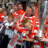 A fan gets up close and personal with the Johnstone's Paint Trophy.