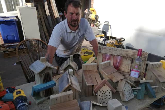 Paul Cook with some of the items he is creating in his front garden in Doncaster
