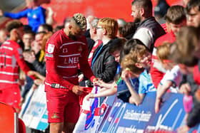 John Bostock signs autographs following Rovers' win over Burton Albion.