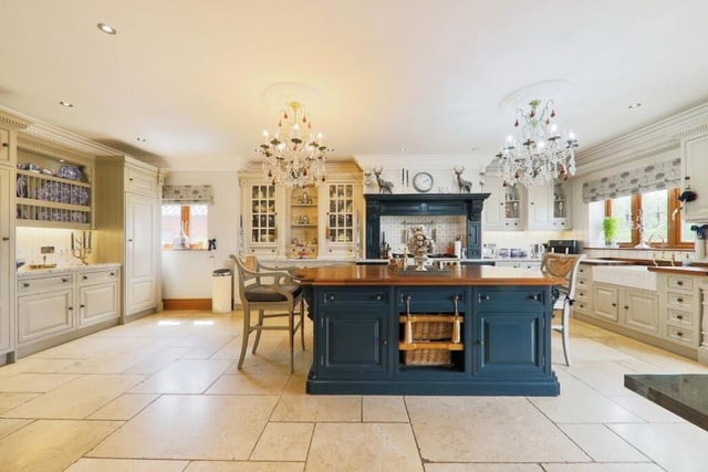A 'show-stopping' Clive Christian designed kitchen with integrated appliances and a large central island.