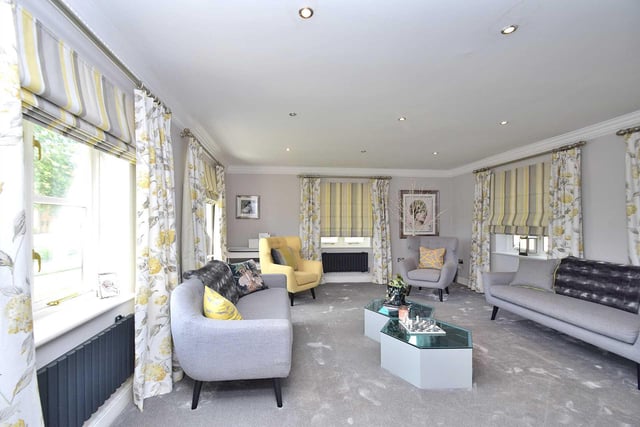There are six reception rooms throughout the property in total, including this cosy and stylish sitting room which is perfect for relaxing.