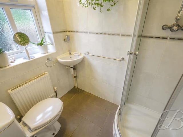 Downstairs, you will also find this shower room, complete with enclosed shower, wash hand basin, low-flush WC and central heating radiator. Next door is a utility room with space for appliances.