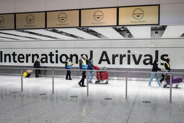 Passengers travelling from one of the countries on the "red list" are escorted through the arrivals area of terminal 5 of Heathrow airport  (Photo by Leon Neal/Getty Images)