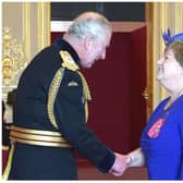Lynne Wade receives her MBE from King Charles at Windsor Castle.