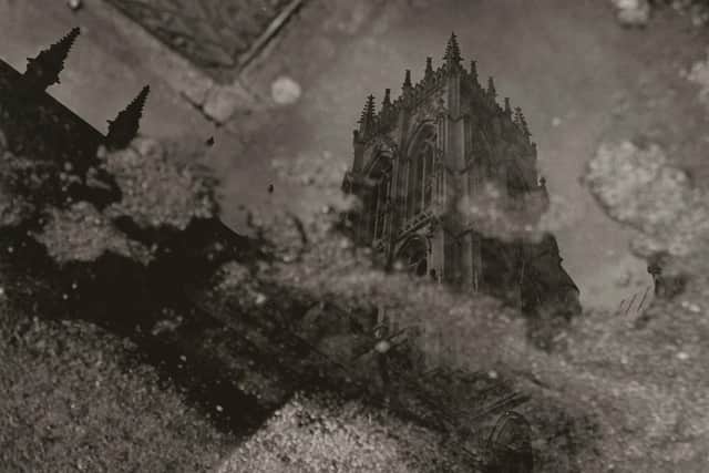 Doncaster Minster  reflected in a puddle of rain water