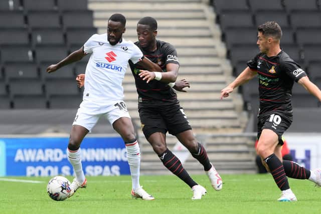 Joseph Olowu (centre) was subbed at half time at MK Dons.