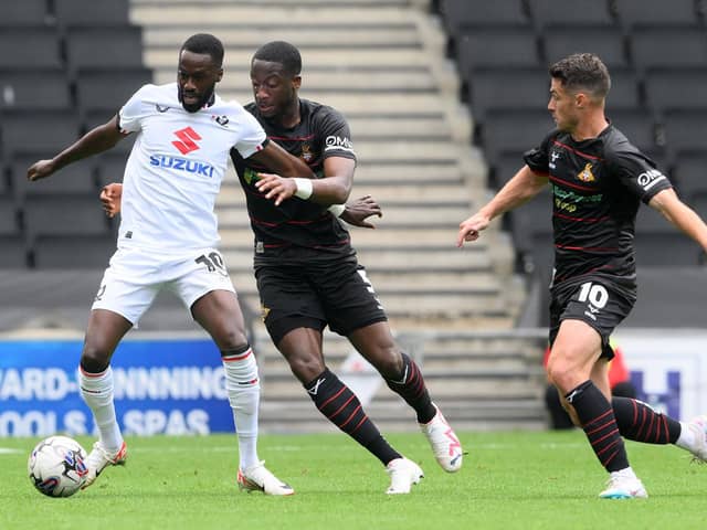 Joseph Olowu (centre) was subbed at half time at MK Dons.