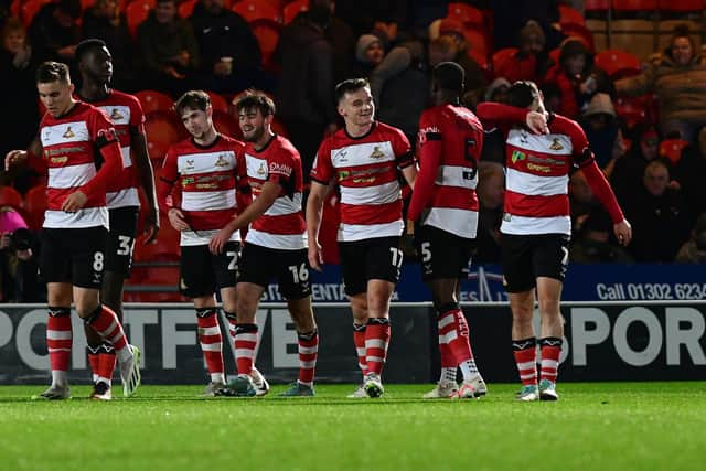 Doncaster's players celebrate Kyle Hurst's goal.