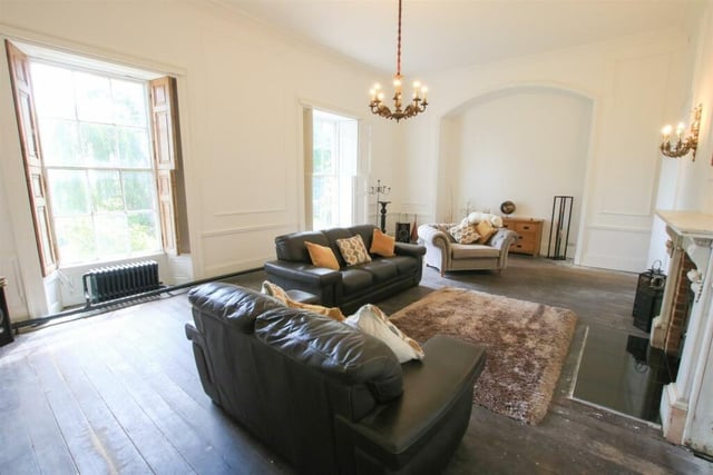 A spacious reception room with feature fireplace.