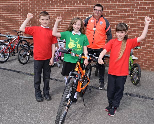Terry Storey, LSA and Academy Bike It Ambassador, Tucker Watson, ten, Chloe Worth, ten and Amy Rose, ten, Bike It Crew members, celebrate coming 1st across Yorkshire and the Humber region. Picture: NDFP-18-05-21-SheepDipBike 2-NMSY