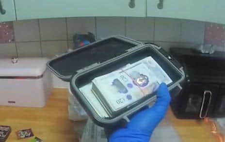 £5,000 in cash was discovered inside a tin.