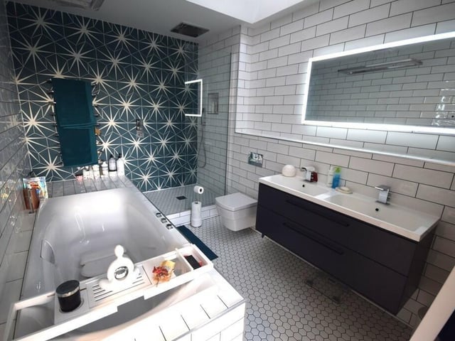 One of three contemporary style bath and shower rooms.